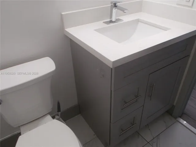 a bathroom with a granite countertop