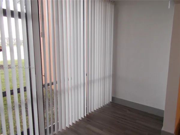 a view of a porch with chairs and backyard