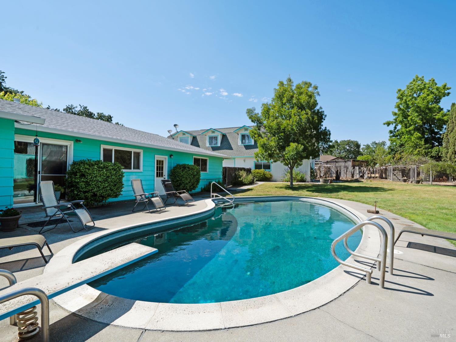a view of a house with swimming pool and sitting area