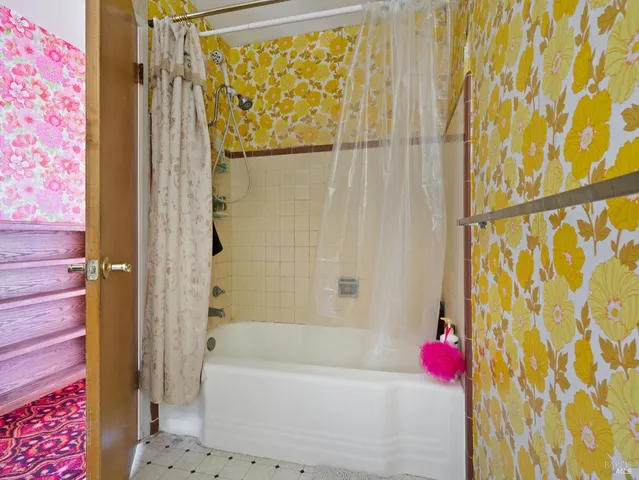 a bathroom with a shower curtain and a bathtub