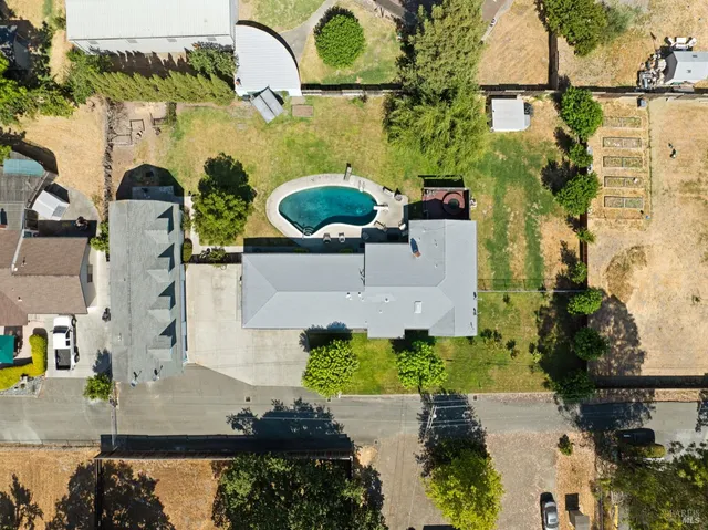 an aerial view of a house with a yard