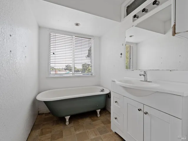 a bathroom with a bathtub and a sink
