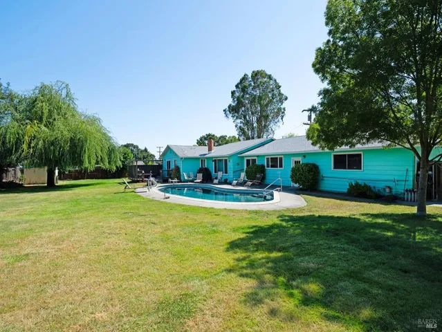 a front view of a house with yard and green space