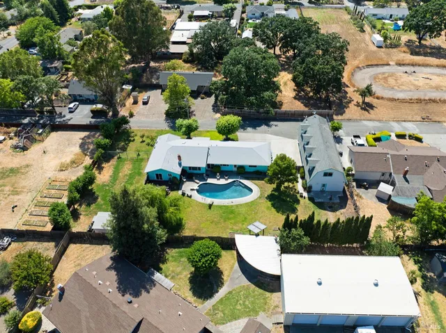 an aerial view of a house with a yard
