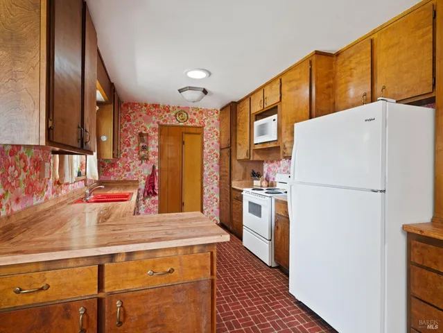 a kitchen with stainless steel appliances a refrigerator and a stove