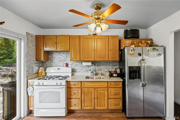 a kitchen with a refrigerator sink and white cabinets