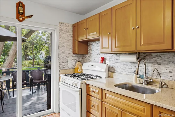 a kitchen with sink a window and cabinets