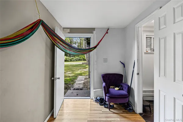a living room with furniture and a mirror