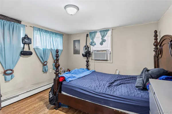 a bedroom with furniture and wooden floor