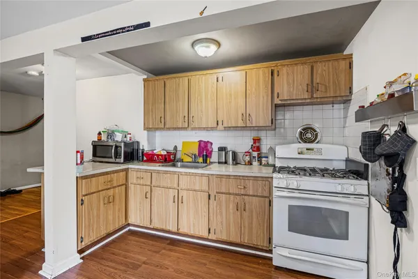 a kitchen with white cabinets and white appliances