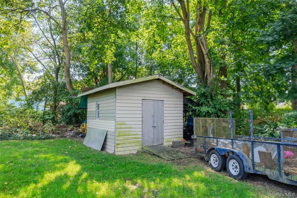 a view of a chair and table in backyard of house
