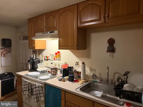 a kitchen with sink and cabinets