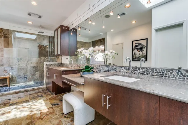 a bathroom with a sink double vanity and a mirror