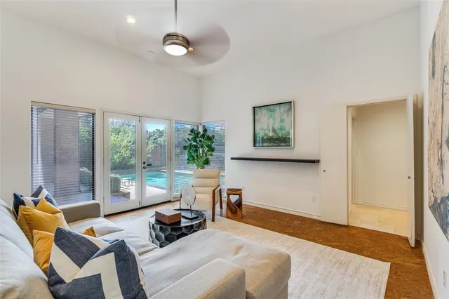 a bedroom with a bed a couch and a large window