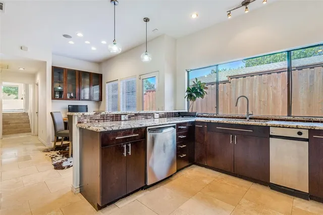 a kitchen with stainless steel appliances granite countertop a sink stove and cabinets