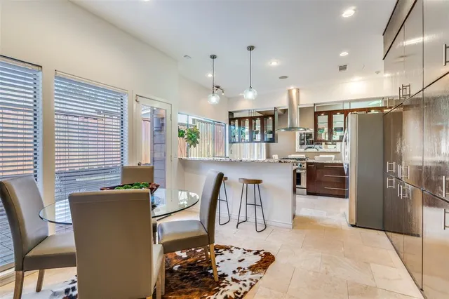 a view of a dining room with furniture and a kitchen