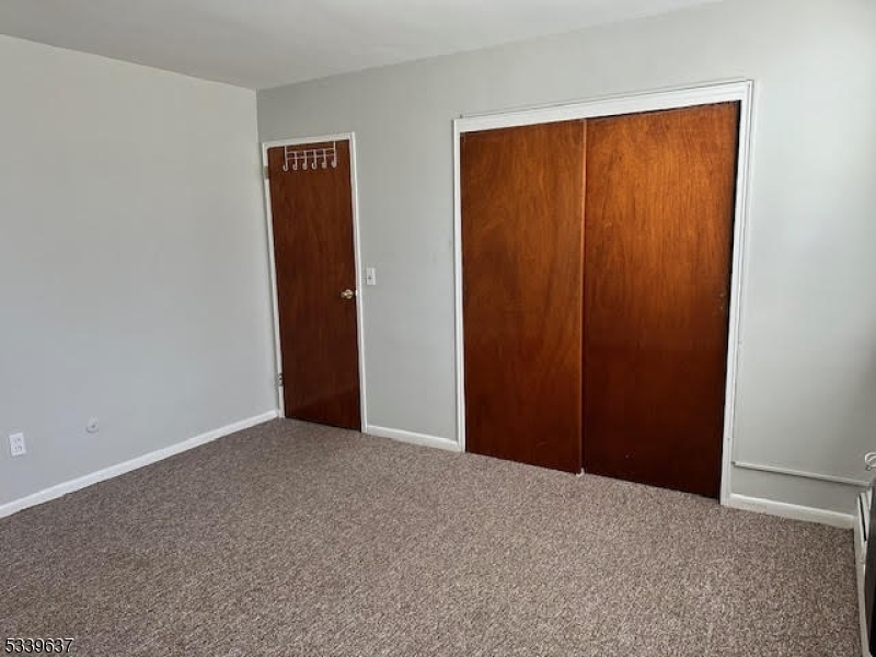 148 Newark Avenue, Unit 3 Belleville, NJ 07109 - Photo 4 of 7 a view of an empty room with closet and entryway