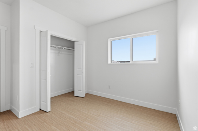 2085 North Main Street, Unit 301 Sunset, UT 84015 - Photo 12 of 20 Bed room featuring light wood-style flooring and a closet