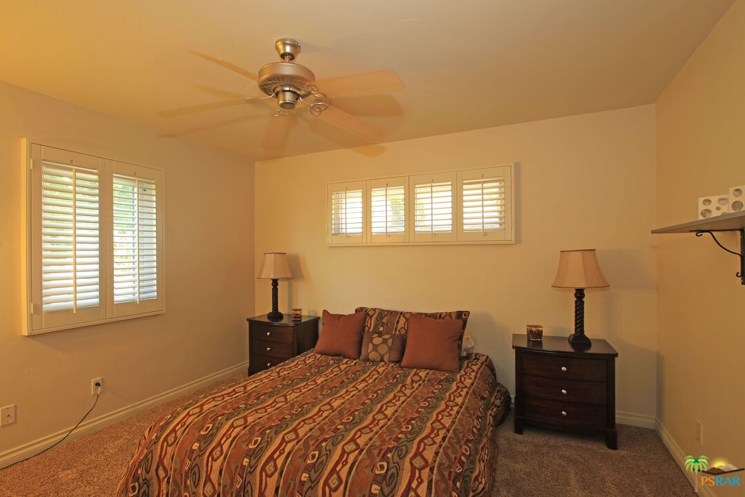 2288 North Deborah Road Palm Springs, CA 92262 - Photo 25 of 33 a bedroom with a bed and a window