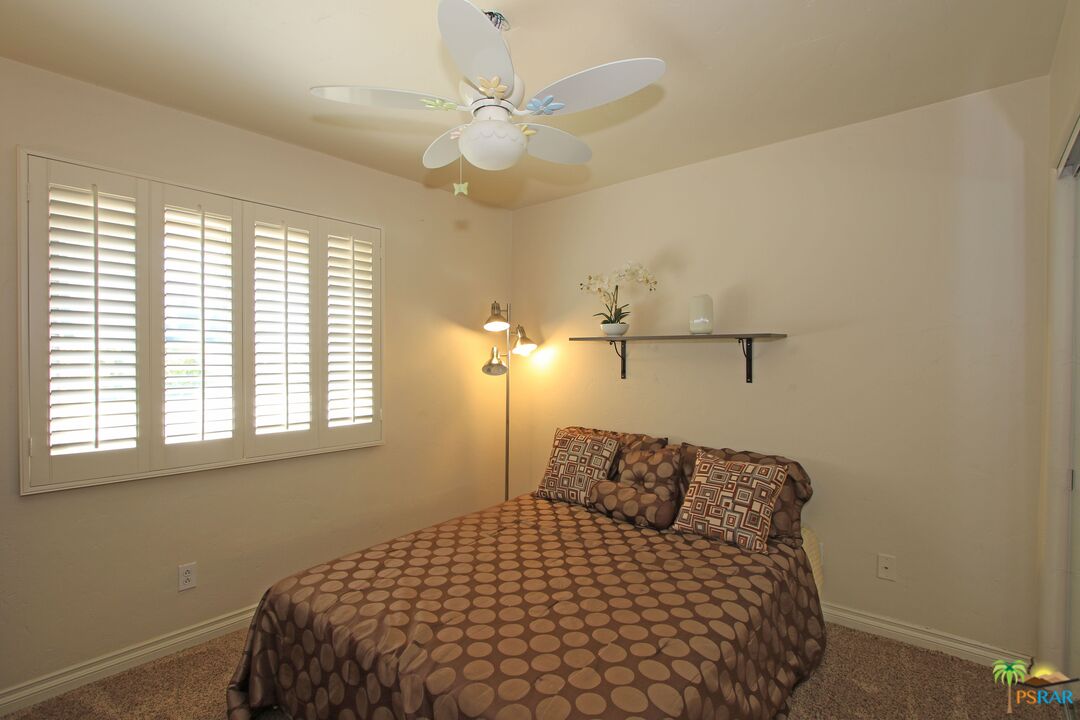 2288 North Deborah Road Palm Springs, CA 92262 - Photo 27 of 33 a bedroom with a bed and window