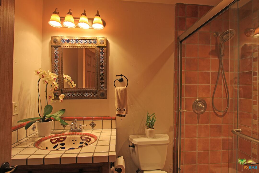 2288 North Deborah Road Palm Springs, CA 92262 - Photo 29 of 33 a bathroom with a sink mirror vanity and toilet