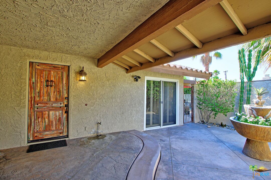 2288 North Deborah Road Palm Springs, CA 92262 - Photo 4 of 33 a view of a patio with table and chairs and potted plants