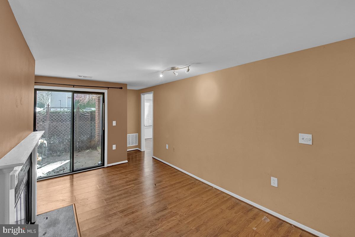 13257 Wonderland Way, Unit 1101 Germantown, MD 20874 - Photo 12 of 51 a view of an empty room with wooden floor and a window