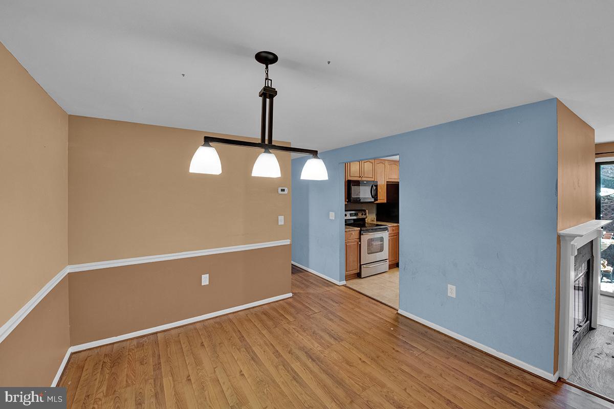 13257 Wonderland Way, Unit 1101 Germantown, MD 20874 - Photo 17 of 51 a view of a room with kitchen appliances and wooden floor