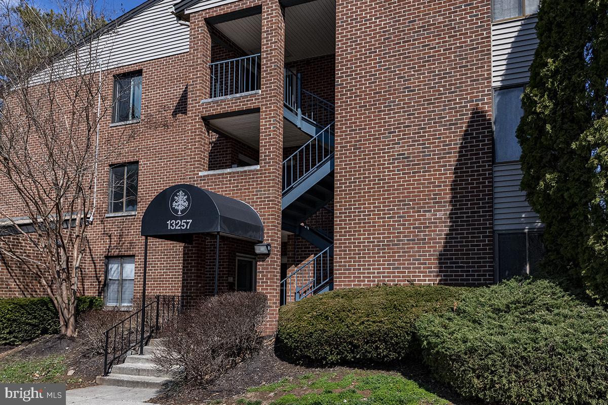 13257 Wonderland Way, Unit 1101 Germantown, MD 20874 - Photo 2 of 51 a front view of a house with a yard