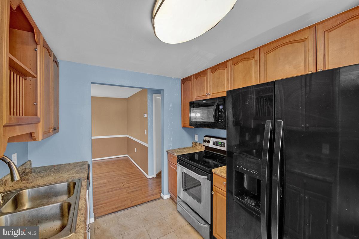 13257 Wonderland Way, Unit 1101 Germantown, MD 20874 - Photo 22 of 51 a kitchen with stainless steel appliances a refrigerator and a sink