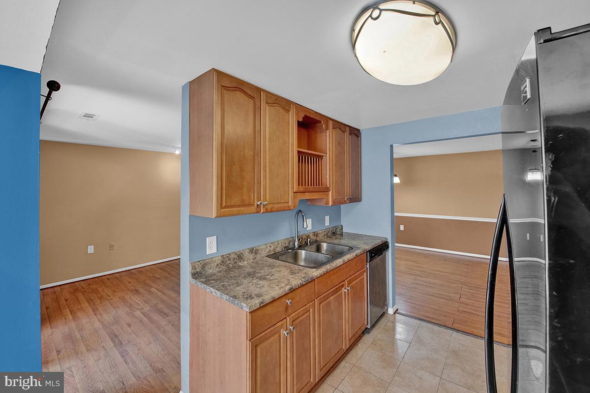 13257 Wonderland Way, Unit 1101 Germantown, MD 20874 - Photo 23 of 51 a kitchen with a sink cabinets and wooden floor