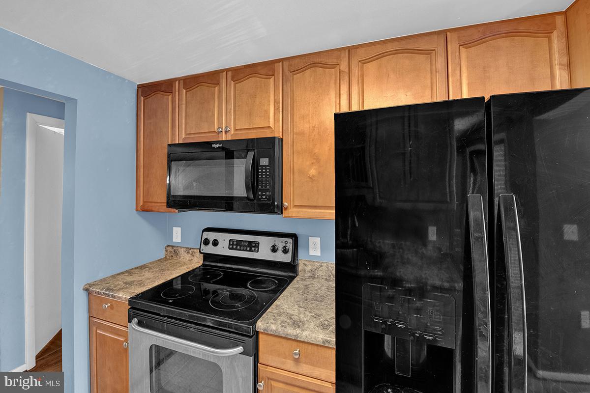13257 Wonderland Way, Unit 1101 Germantown, MD 20874 - Photo 25 of 51 a kitchen with a refrigerator stove and microwave