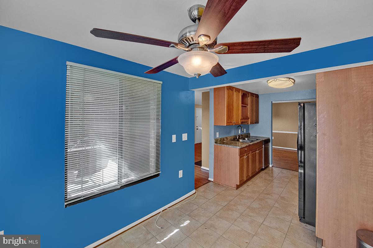 13257 Wonderland Way, Unit 1101 Germantown, MD 20874 - Photo 28 of 51 a view of a kitchen with a sink and a refrigerator