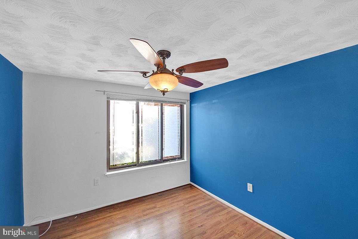 13257 Wonderland Way, Unit 1101 Germantown, MD 20874 - Photo 34 of 51 a view of empty room with window and wooden floor