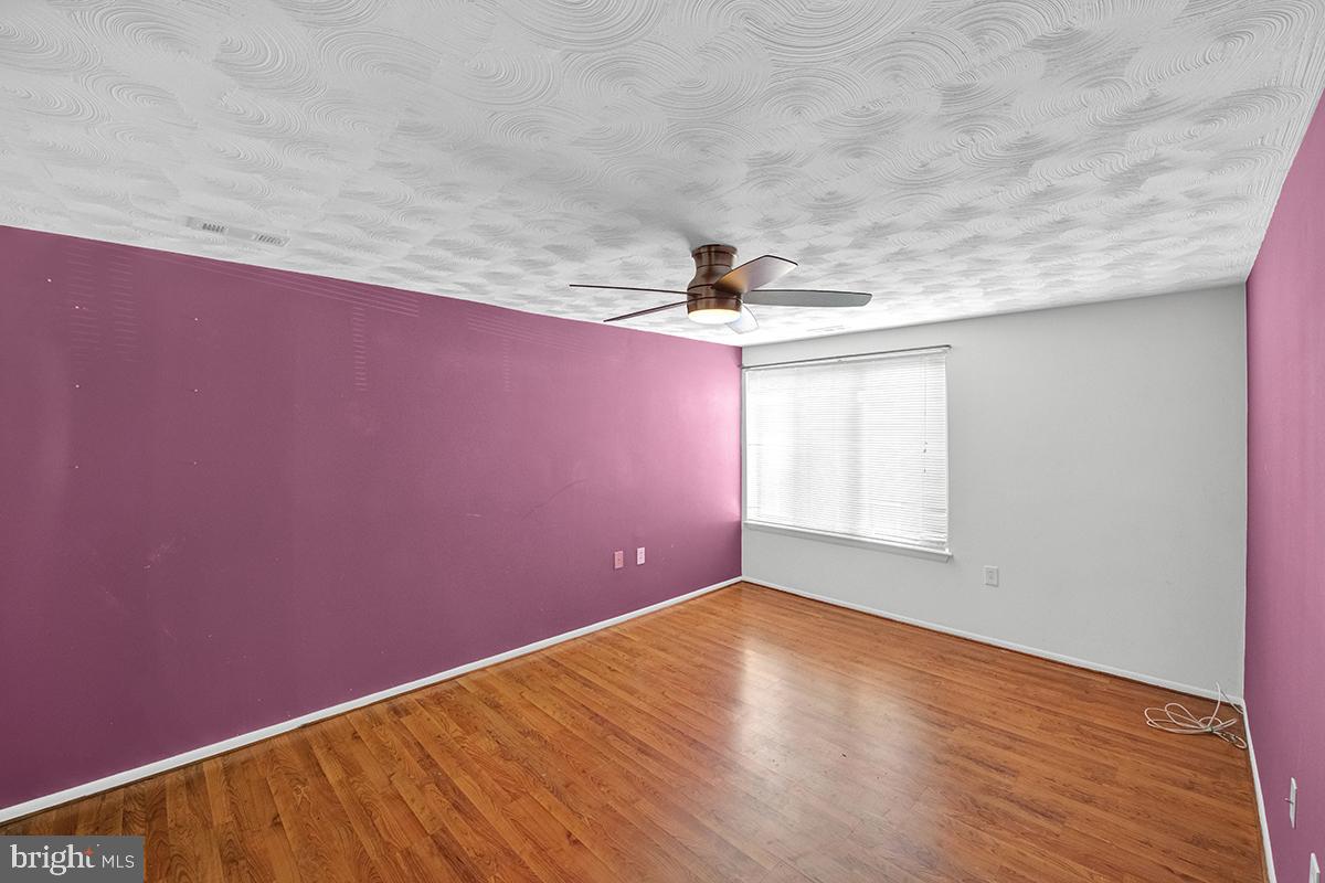 13257 Wonderland Way, Unit 1101 Germantown, MD 20874 - Photo 37 of 51 an empty room with wooden floor