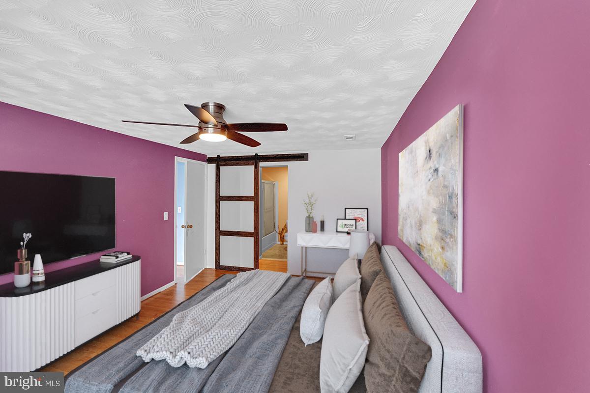 13257 Wonderland Way, Unit 1101 Germantown, MD 20874 - Photo 6 of 51 a bedroom with a bed and a flat screen tv