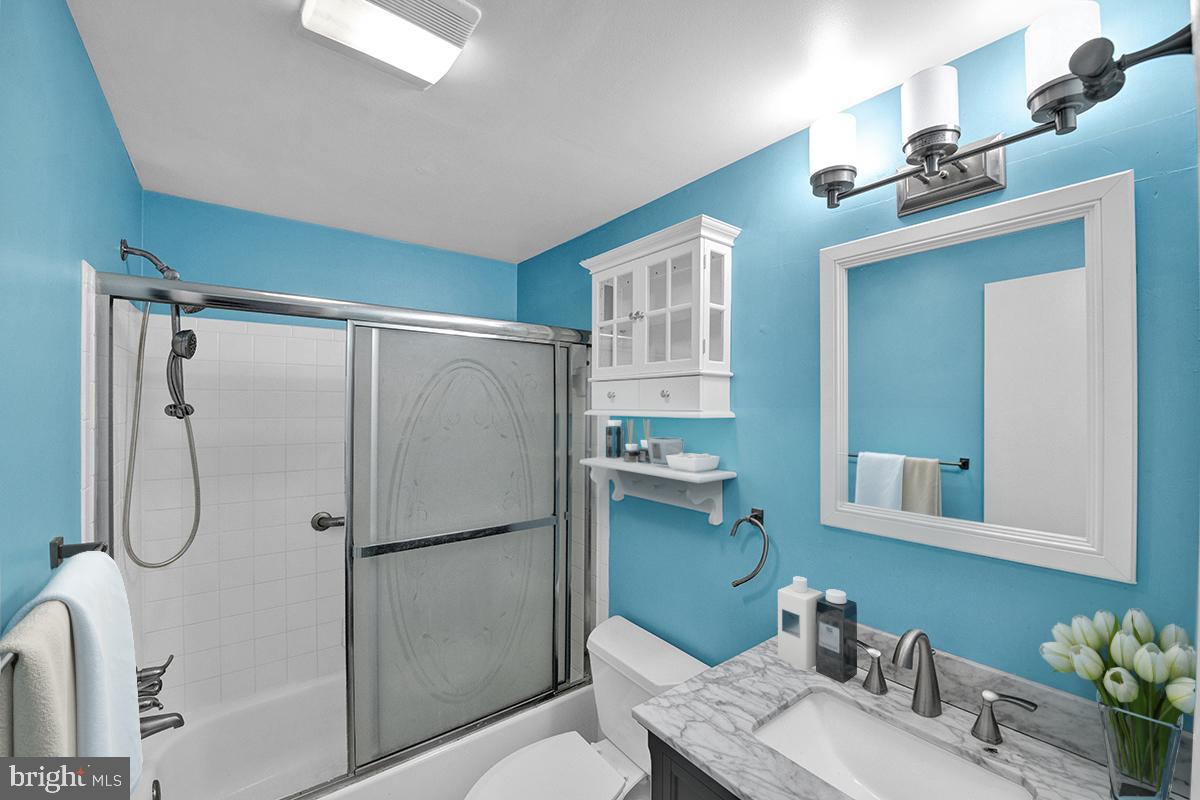 13257 Wonderland Way, Unit 1101 Germantown, MD 20874 - Photo 8 of 51 a bathroom with a shower sink and mirror