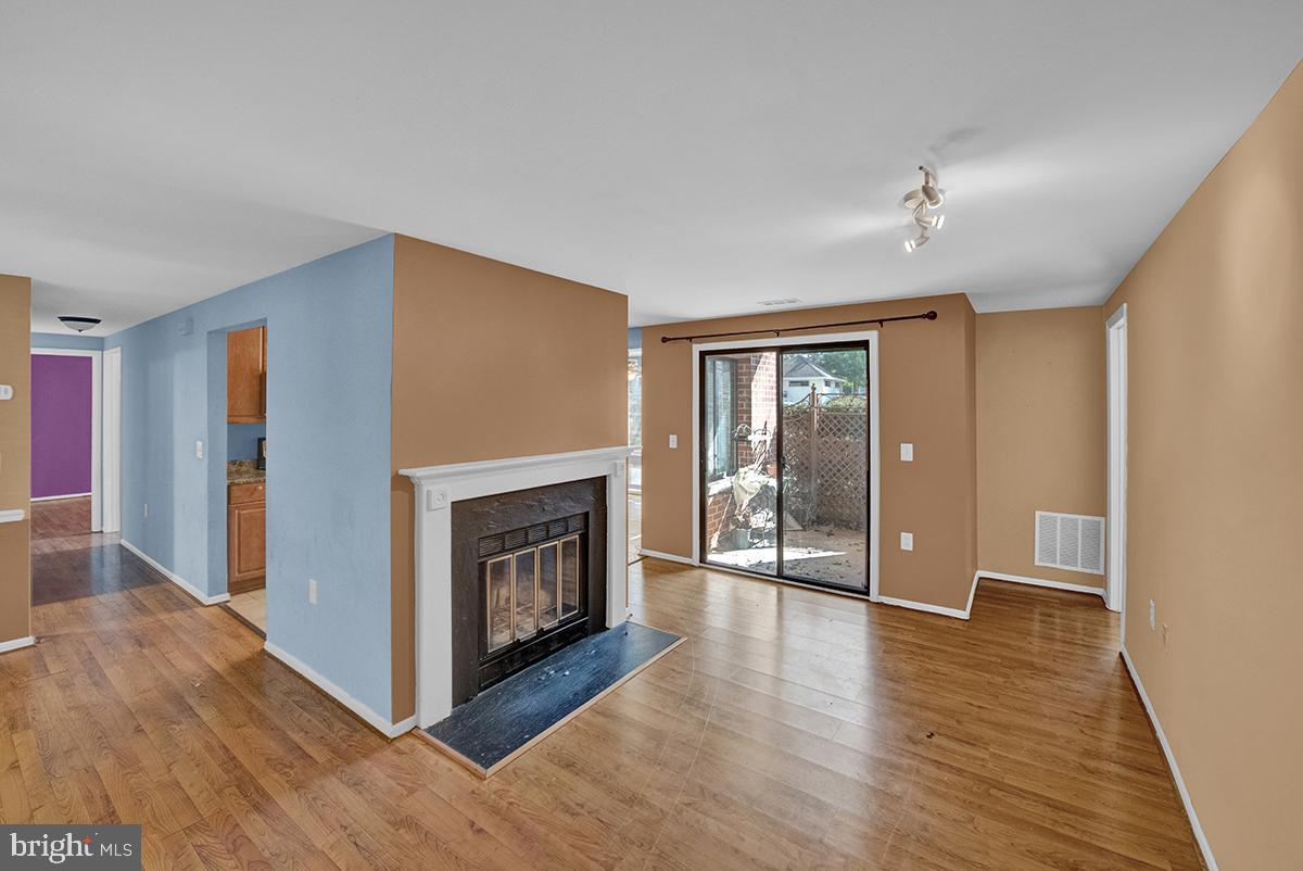 13257 Wonderland Way, Unit 1101 Germantown, MD 20874 - Photo 9 of 51 a view of a livingroom with wooden floor a fireplace and window