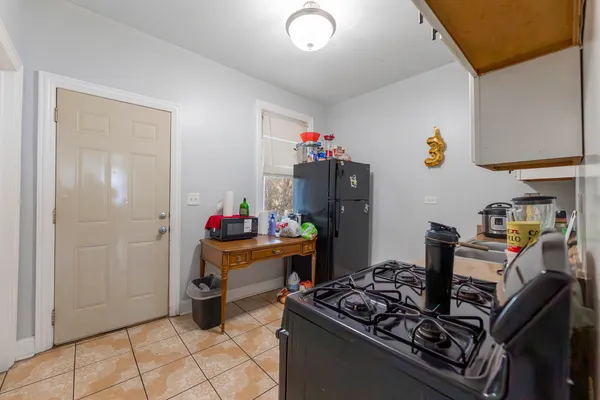 a kitchen with stainless steel appliances granite countertop a sink and a refrigerator