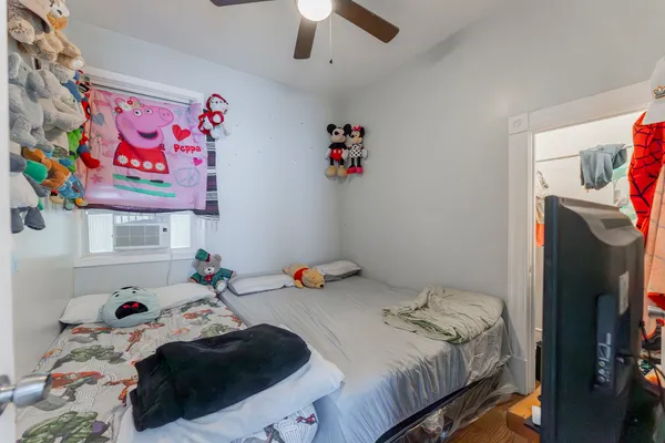 a bedroom with a bed and a window