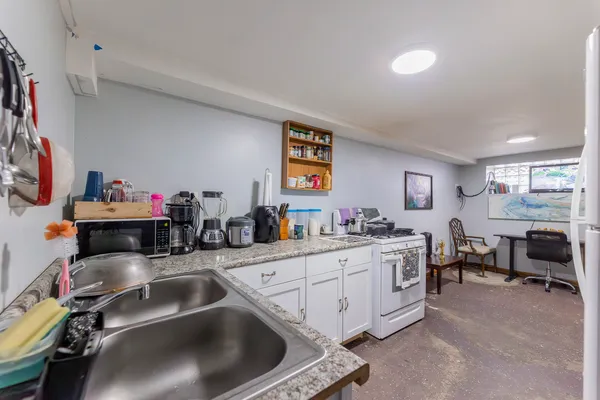 a kitchen filled a sink a stove and a refrigerator