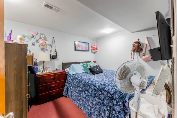 a bedroom with a bed and dresser