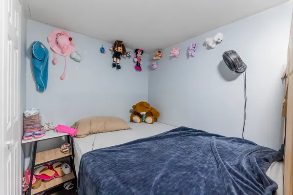 a bedroom with a bed and book shelf