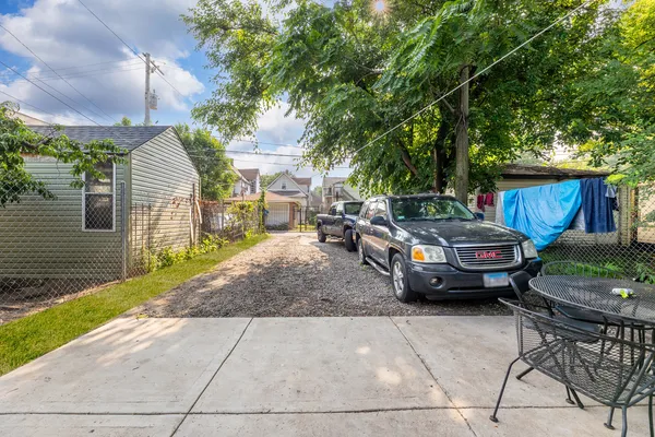 a couple of cars parked in front of a house