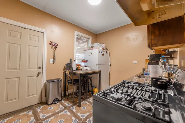 a kitchen with stainless steel appliances granite countertop a stove and a refrigerator