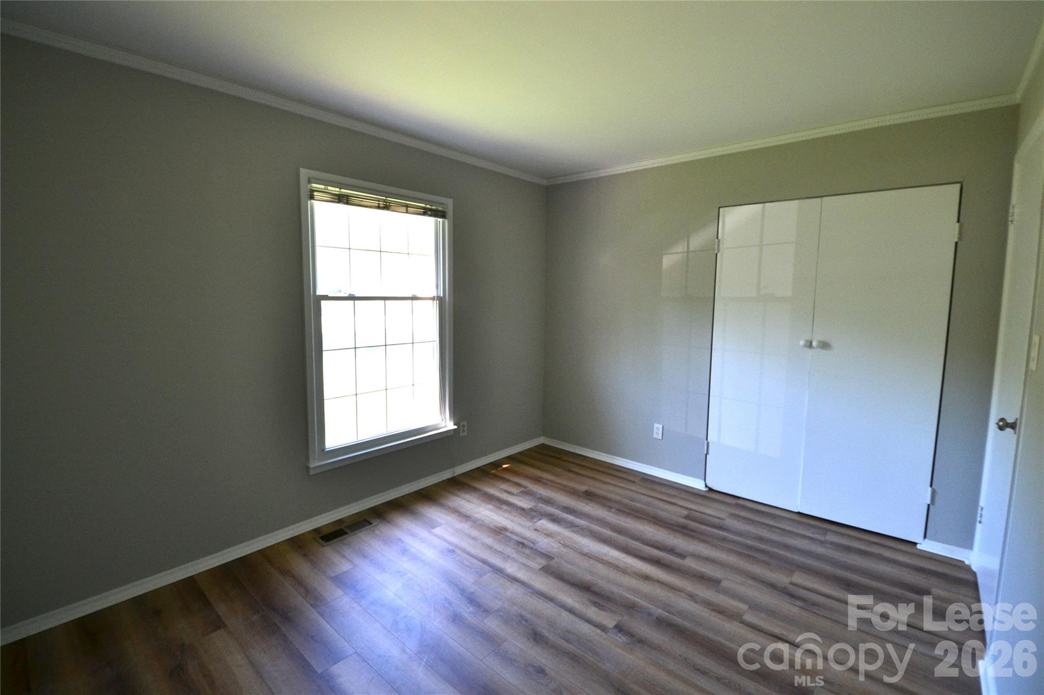 1422 Thermal Road Charlotte, NC 28212 - Photo 23 of 40 an empty room with wooden floor and windows