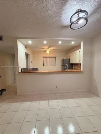a kitchen with a stove a refrigerator and a sink