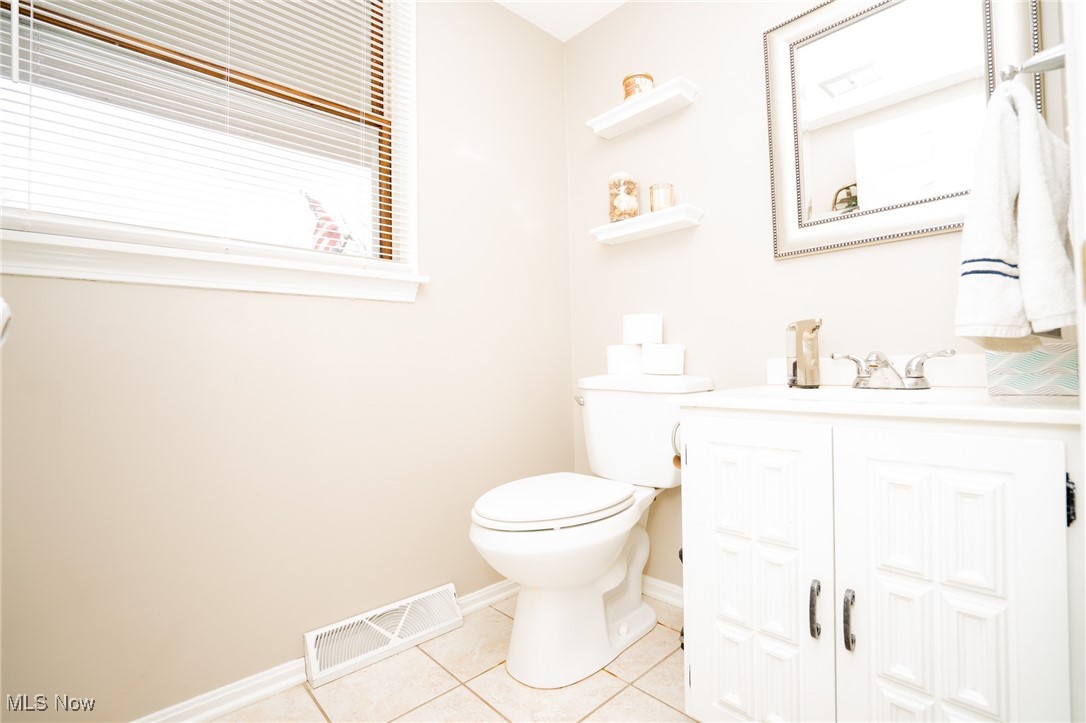 8651 King Graves Road Northeast Warren, OH 44484 - Photo 8 of 24 Bathroom with tile patterned flooring, vanity, and toilet