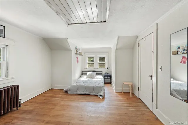 a bedroom with a bed and a large window