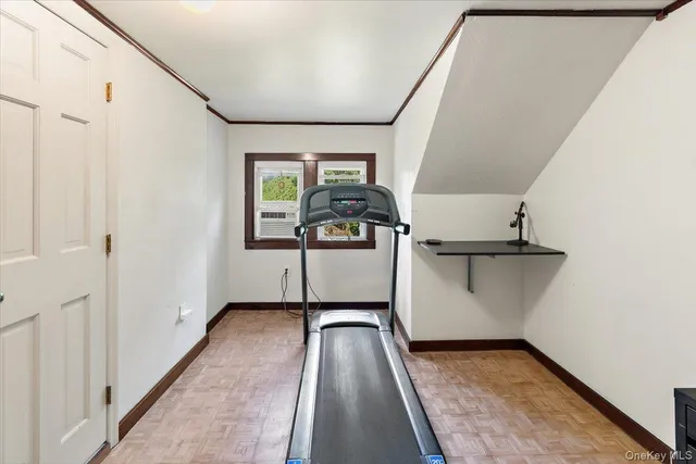 a view of a hallway with a car parked in garage
